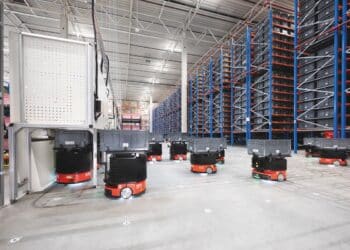 Autonomous mobile robots transport goods across warehouse floors, reducing operator travel time.