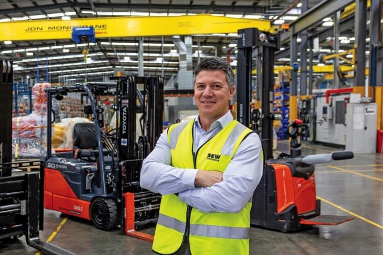 SEW-EURODRIVE’s national procurement manager, Fred Pizzicara, with Toyota material handling equipment at the company’s Australian facility. Images: TMHA